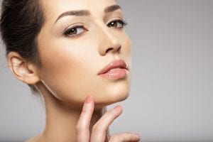 Portrait of beautiful young woman with clean face. Beautiful woman face close up studio.
